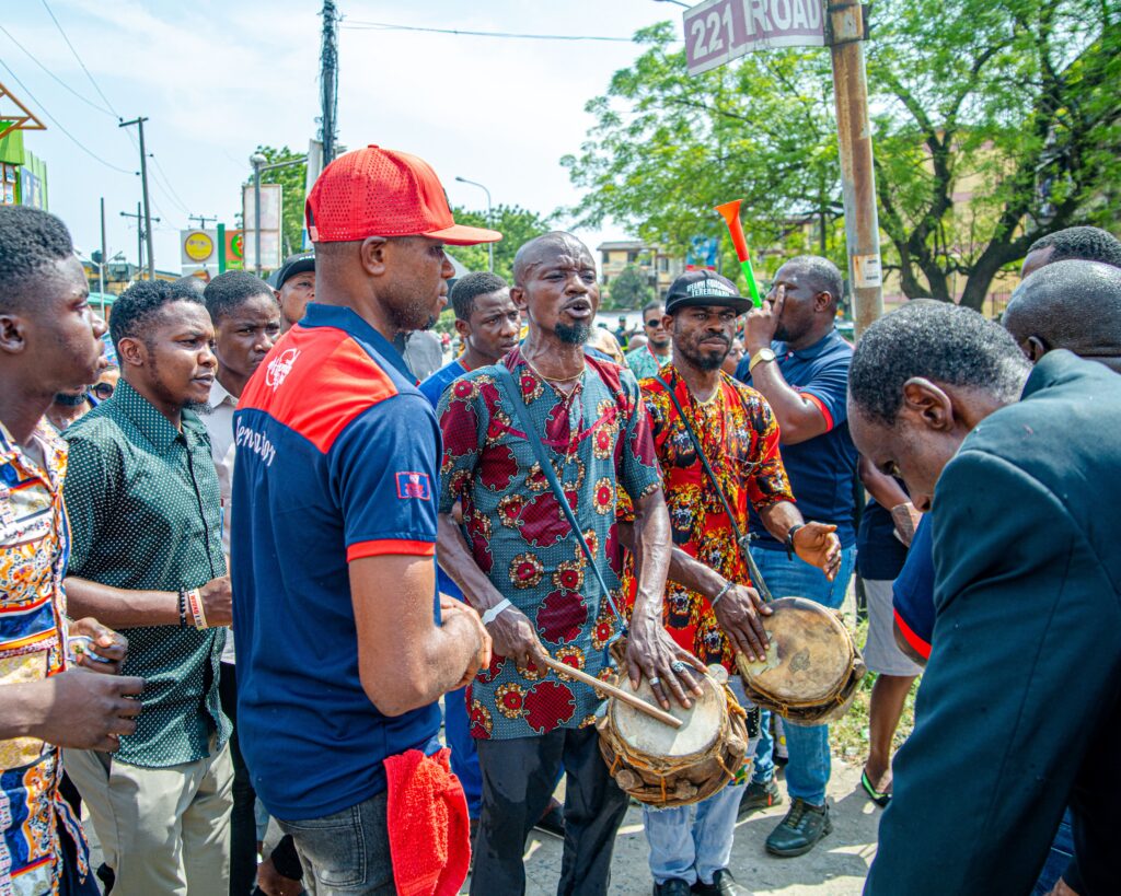 Energetic street musicians performing traditional drumming in Lagos, Nigeria.