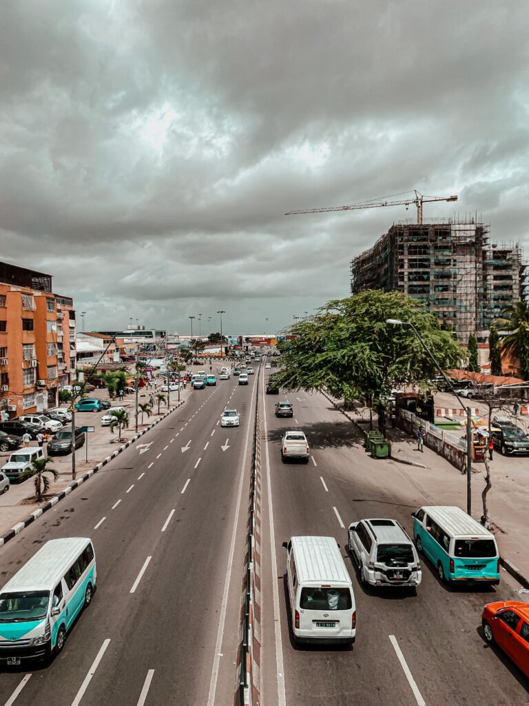 A bustling street in Luanda, Angola showing urban development with traffic and construction.